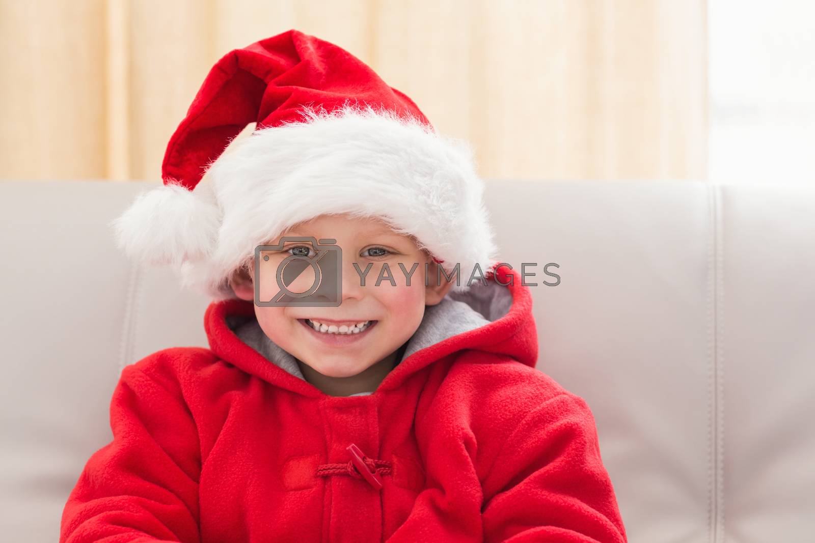 Royalty free image of Festive little boy smiling at camera by Wavebreakmedia