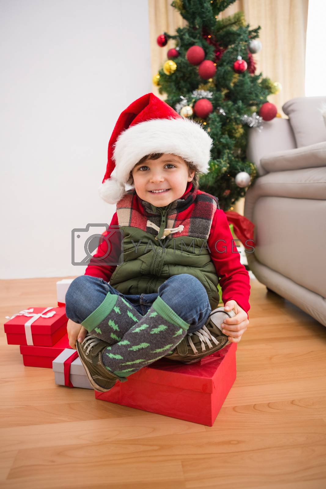 Royalty free image of Cute festive little boy smiling at camera by Wavebreakmedia