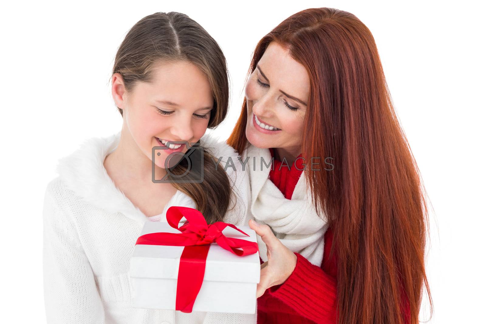 Royalty free image of Mother and daughter opening christmas gift by Wavebreakmedia