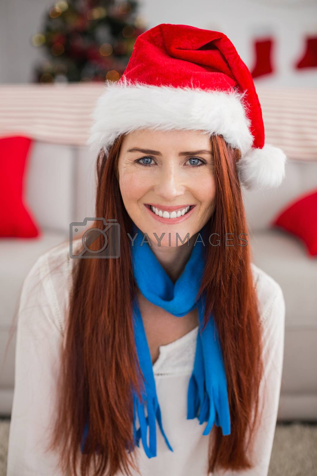 Royalty free image of Festive redhead smiling at camera by Wavebreakmedia