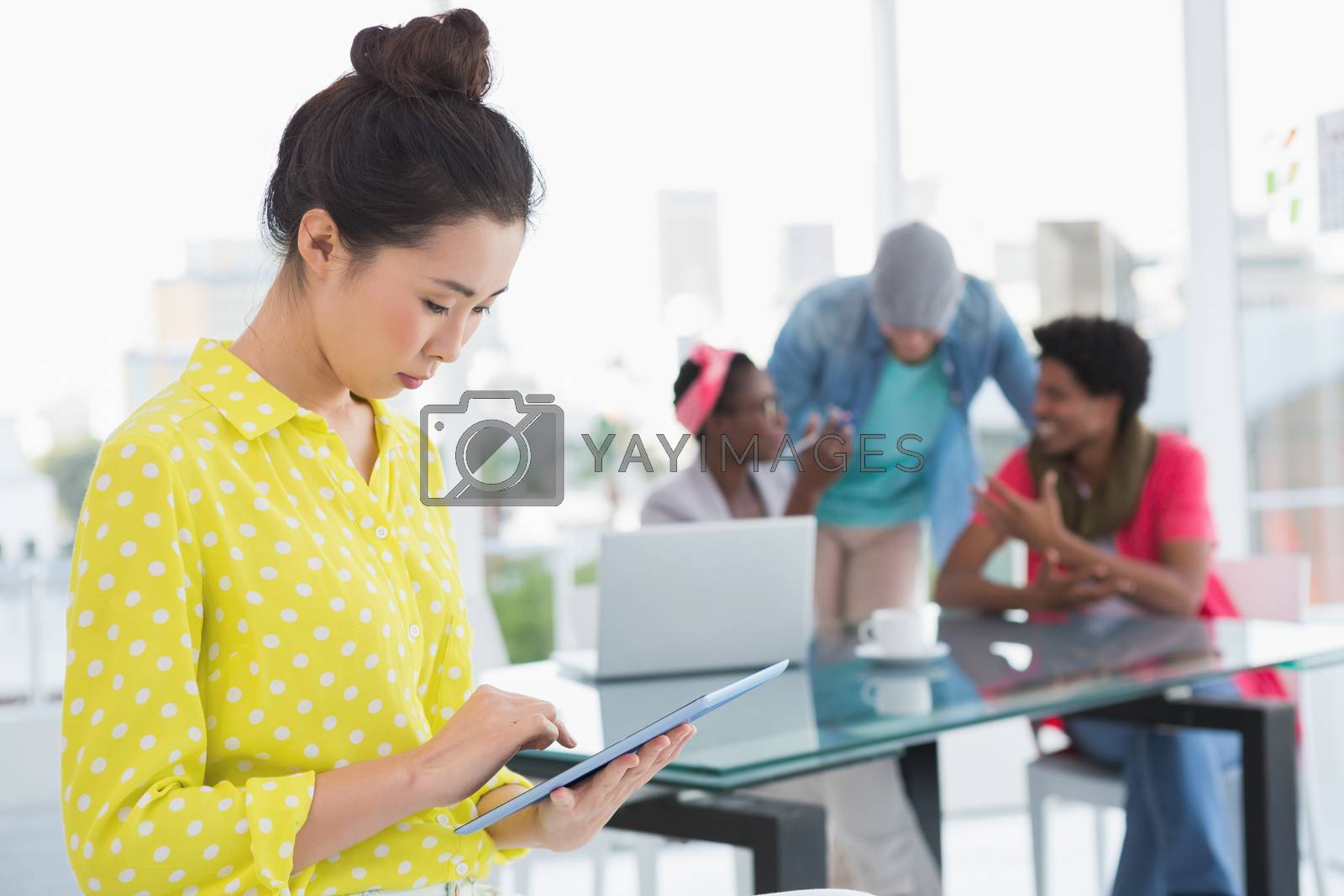 Royalty free image of Young creative woman using her tablet by Wavebreakmedia