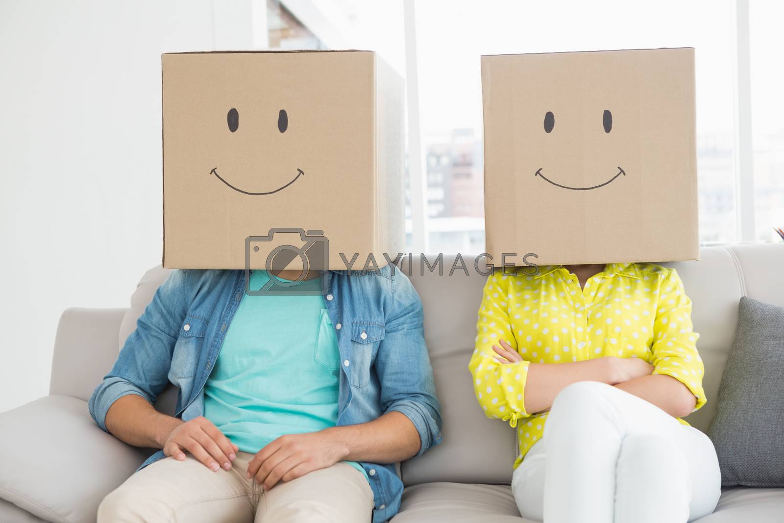 Royalty free image of Young creative team wearing boxes on head by Wavebreakmedia