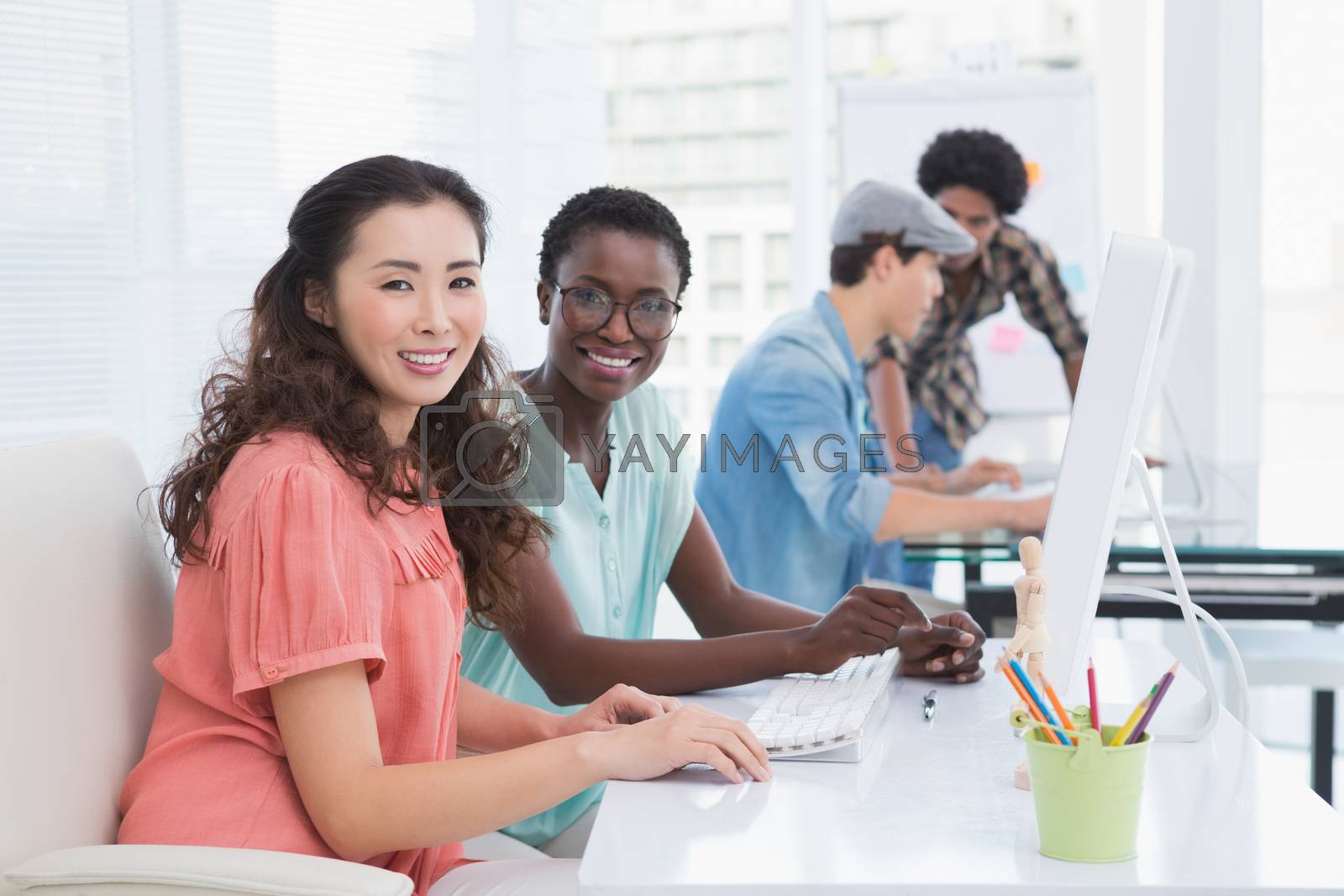 Royalty free image of Young creative team working at desk by Wavebreakmedia