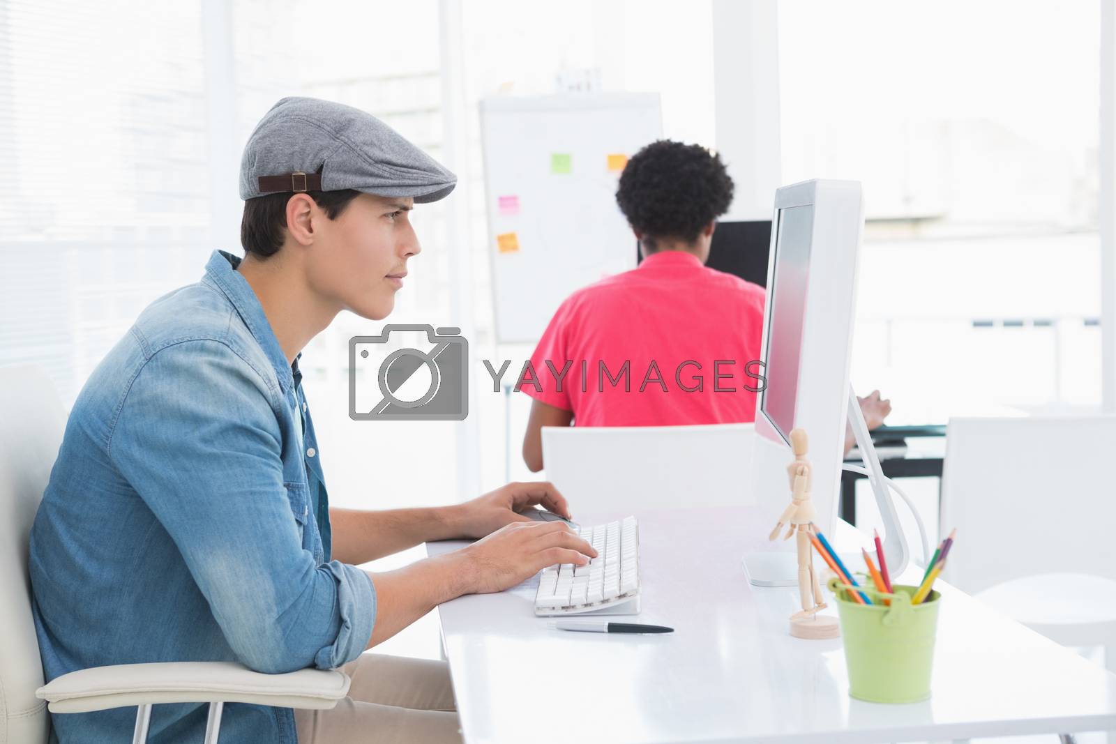 Royalty free image of Young creative man working at desk by Wavebreakmedia