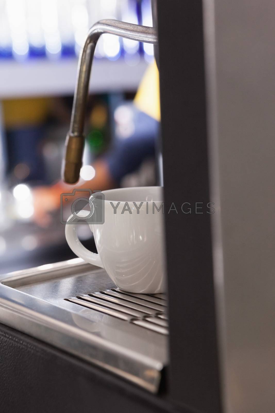 Royalty free image of Cup of coffee on the espresso maker by Wavebreakmedia