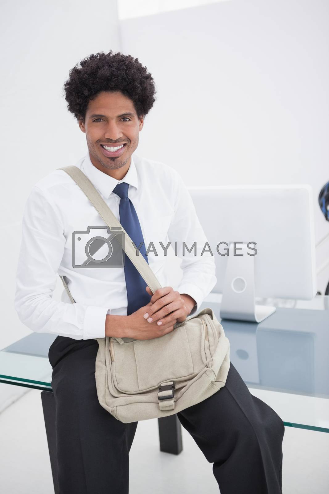 Royalty free image of Smiling businessman with shoulder bag  by Wavebreakmedia