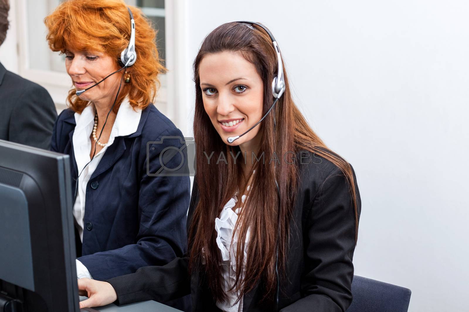 Royalty free image of friendly callcenter agent operator with headset telephone  by juniart