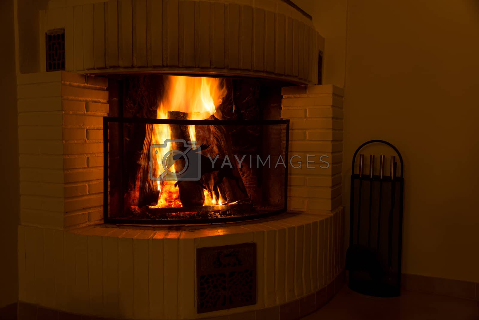 Royalty free image of fireplace with burning logs by Nanisimova