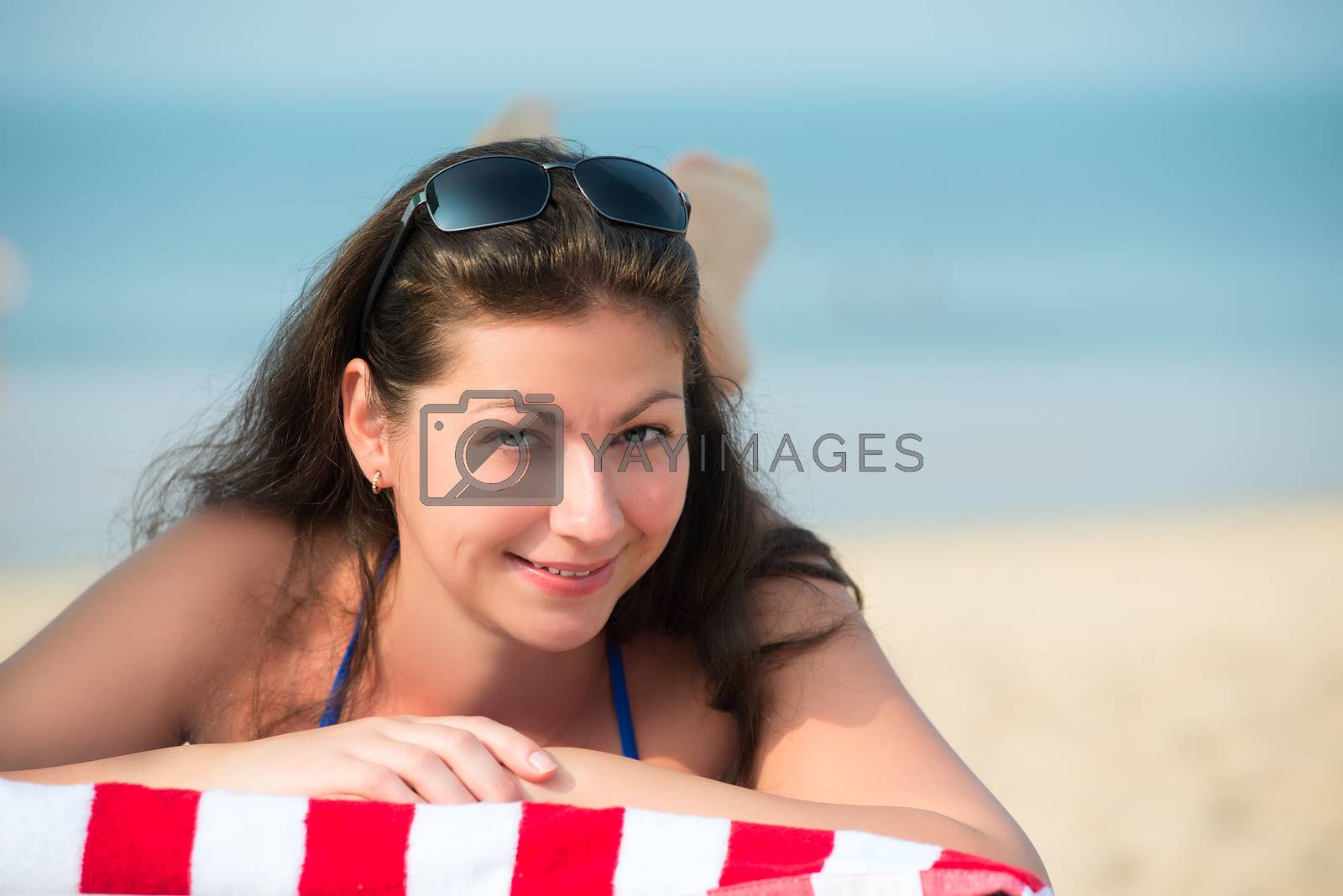 Royalty free image of beautiful young woman lying on a lounger near the sea by kosmsos111