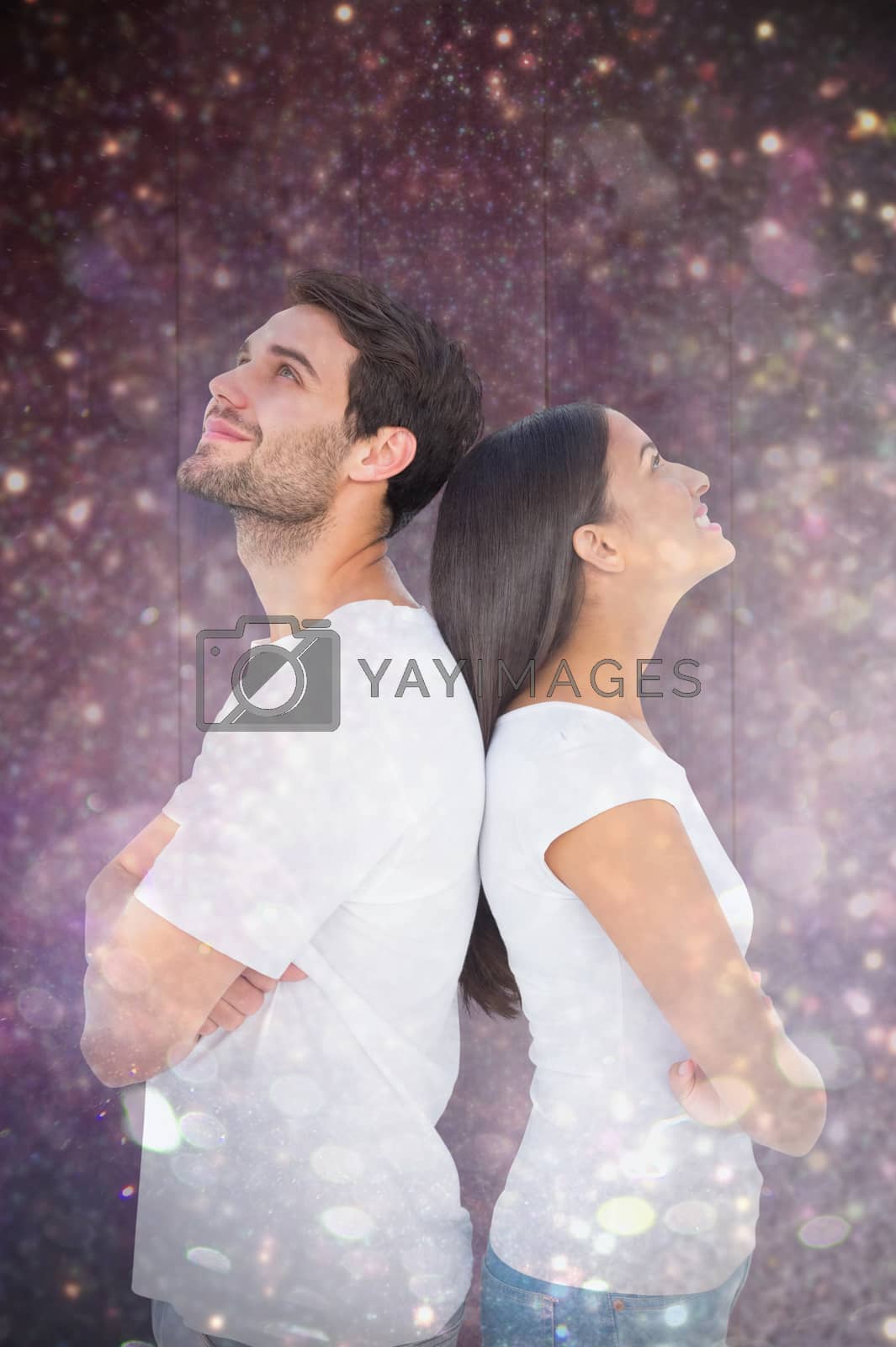 Royalty free image of Composite image of happy couple standing looking up by Wavebreakmedia