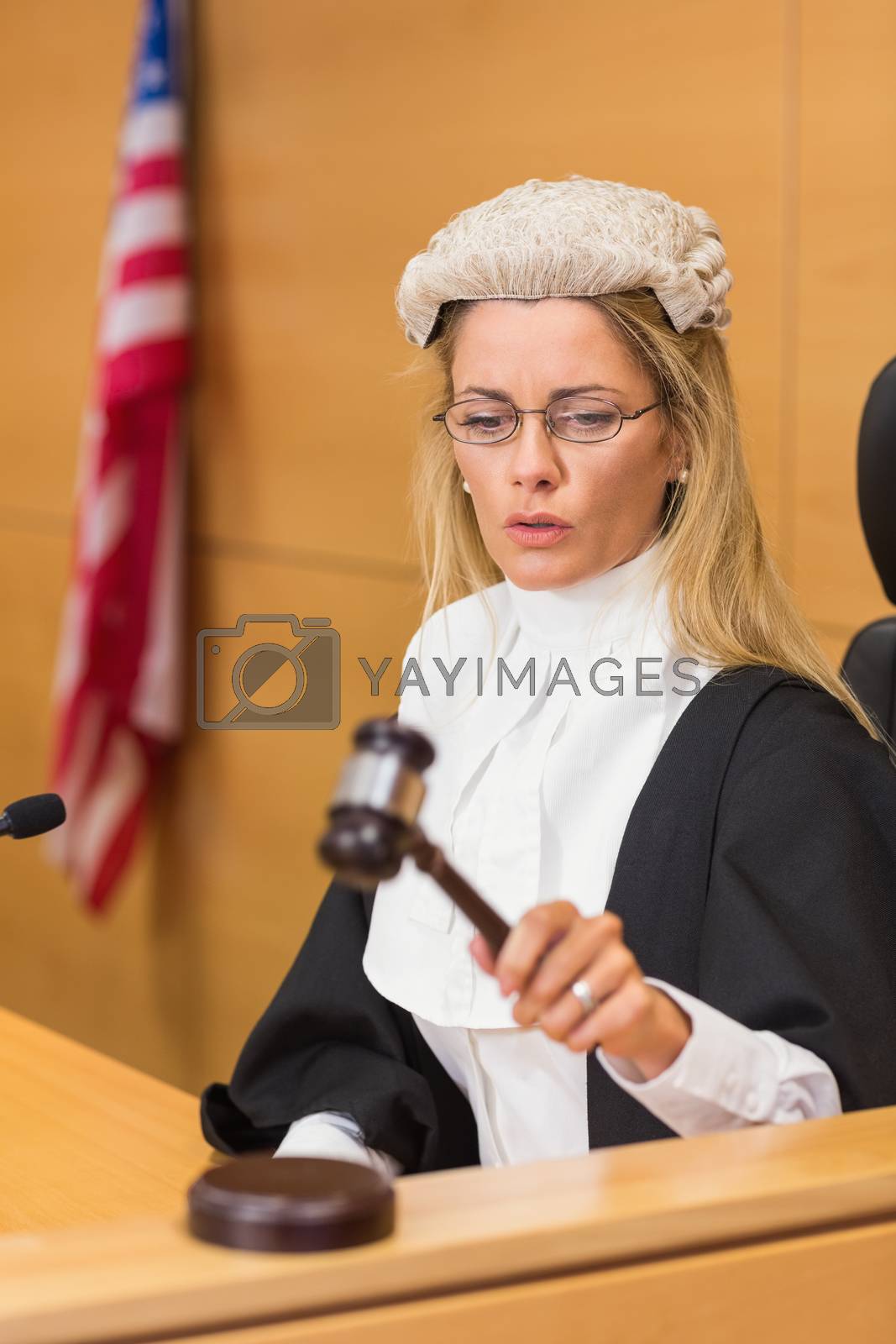 Royalty free image of Stern judge sitting and listening by Wavebreakmedia
