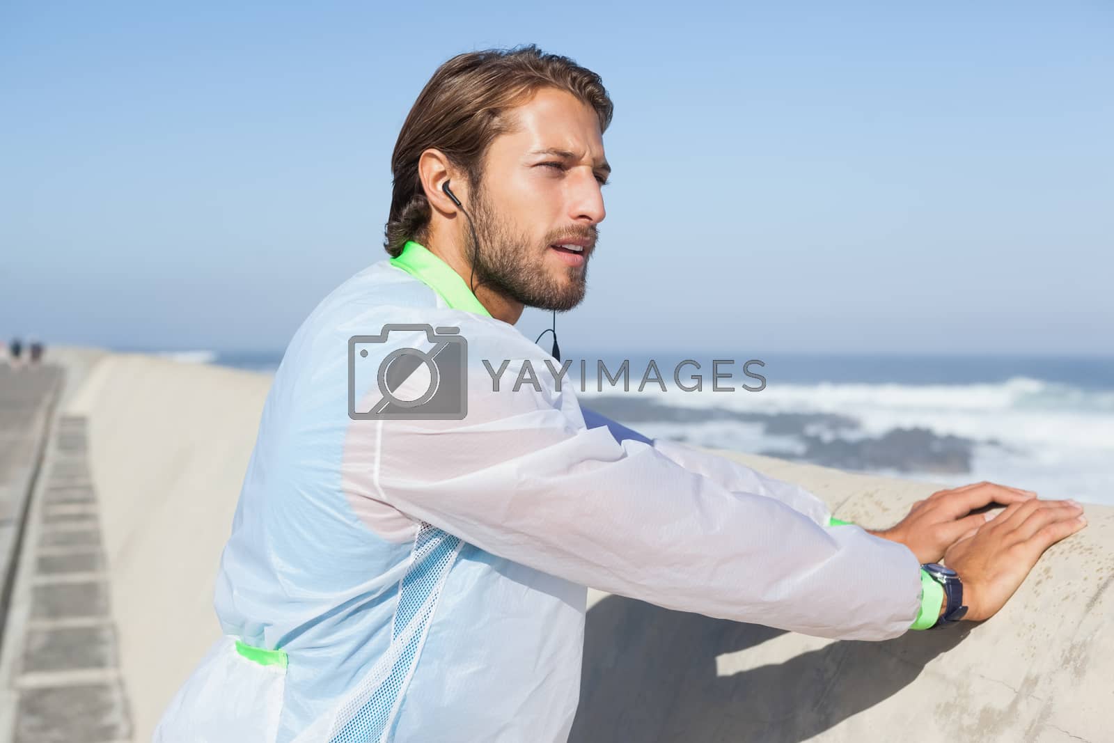 Royalty free image of Fit man warming up on promenade by Wavebreakmedia