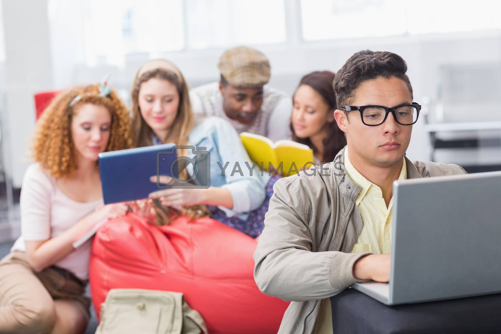 Royalty free image of Fashion student using his laptop by Wavebreakmedia