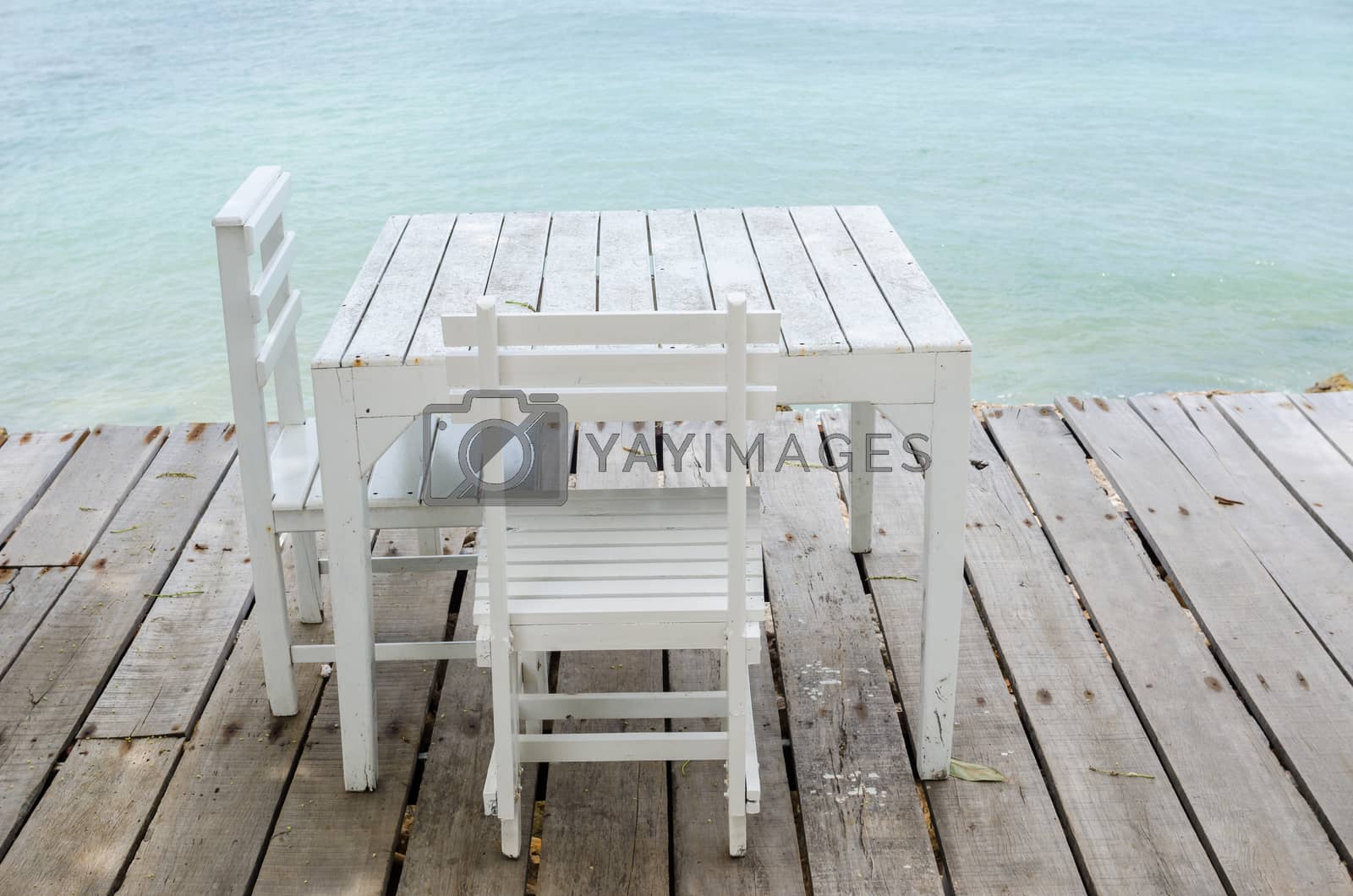 Royalty free image of Wood dock White chair and table by sweetcrisis