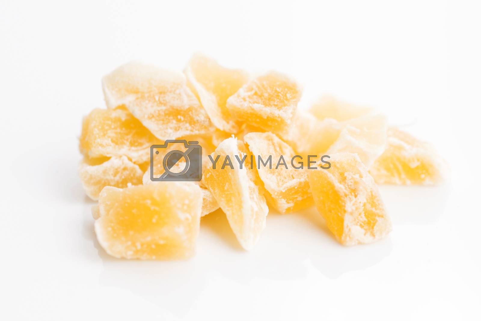 Royalty free image of Caramelized ginger candy pieces isolated on white background by joannawnuk