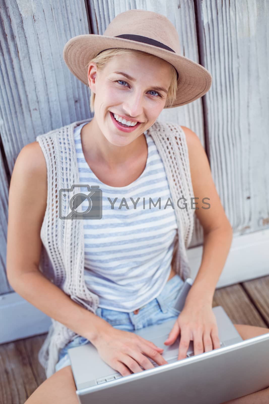 Royalty free image of Pretty blonde woman using her laptop by Wavebreakmedia