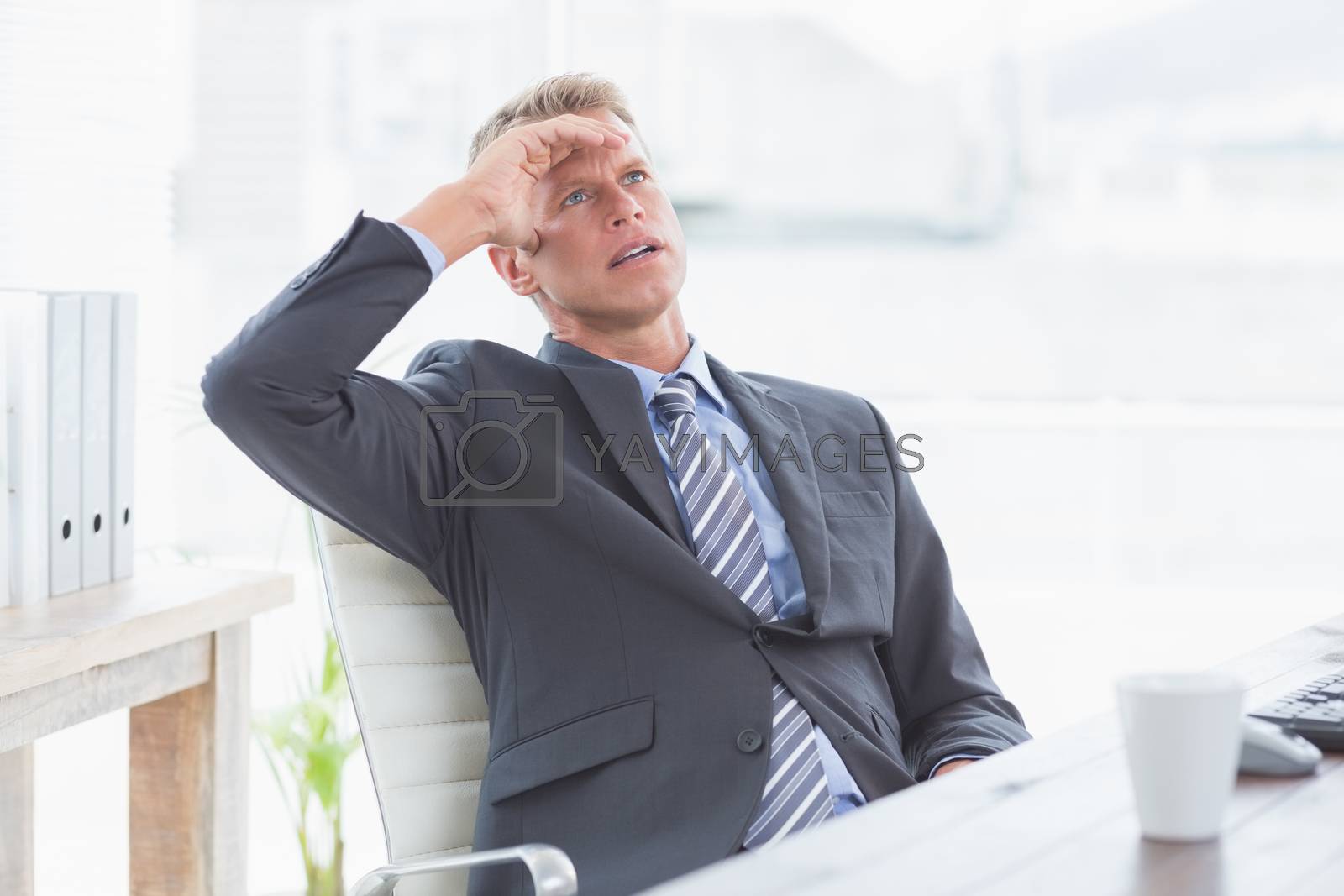 Royalty free image of Businessman with his hand on his forehead by Wavebreakmedia