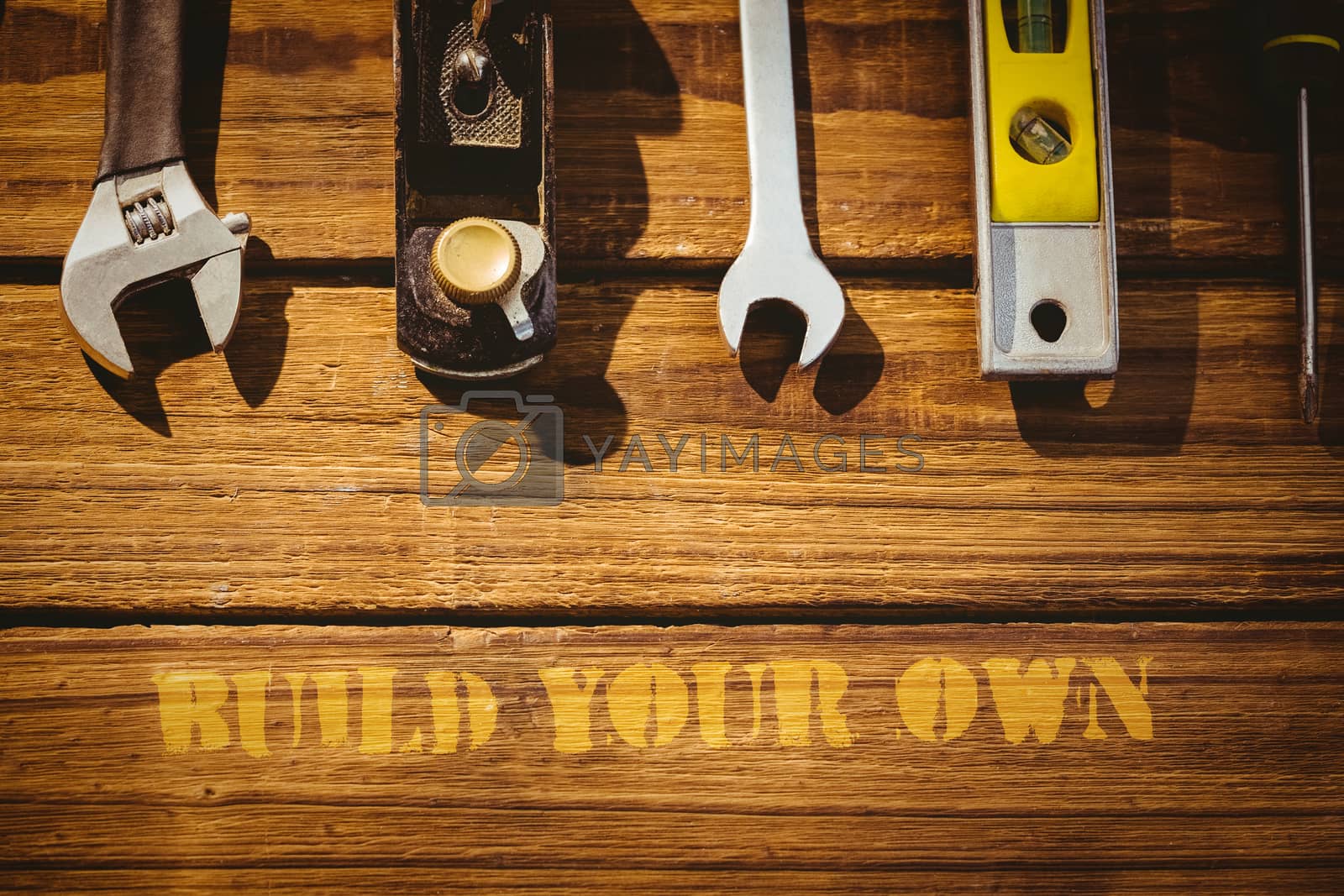 Royalty free image of Build your own against tools on desk by Wavebreakmedia