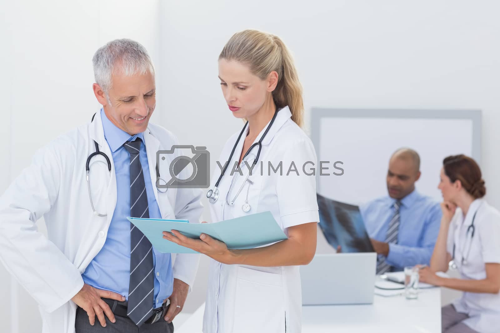 Royalty free image of Team of doctors working on their files by Wavebreakmedia