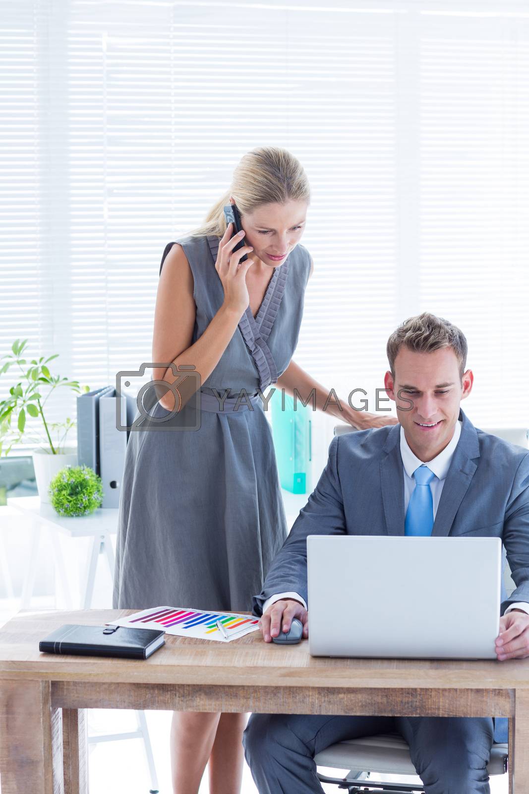 Royalty free image of Business people working together on laptop by Wavebreakmedia