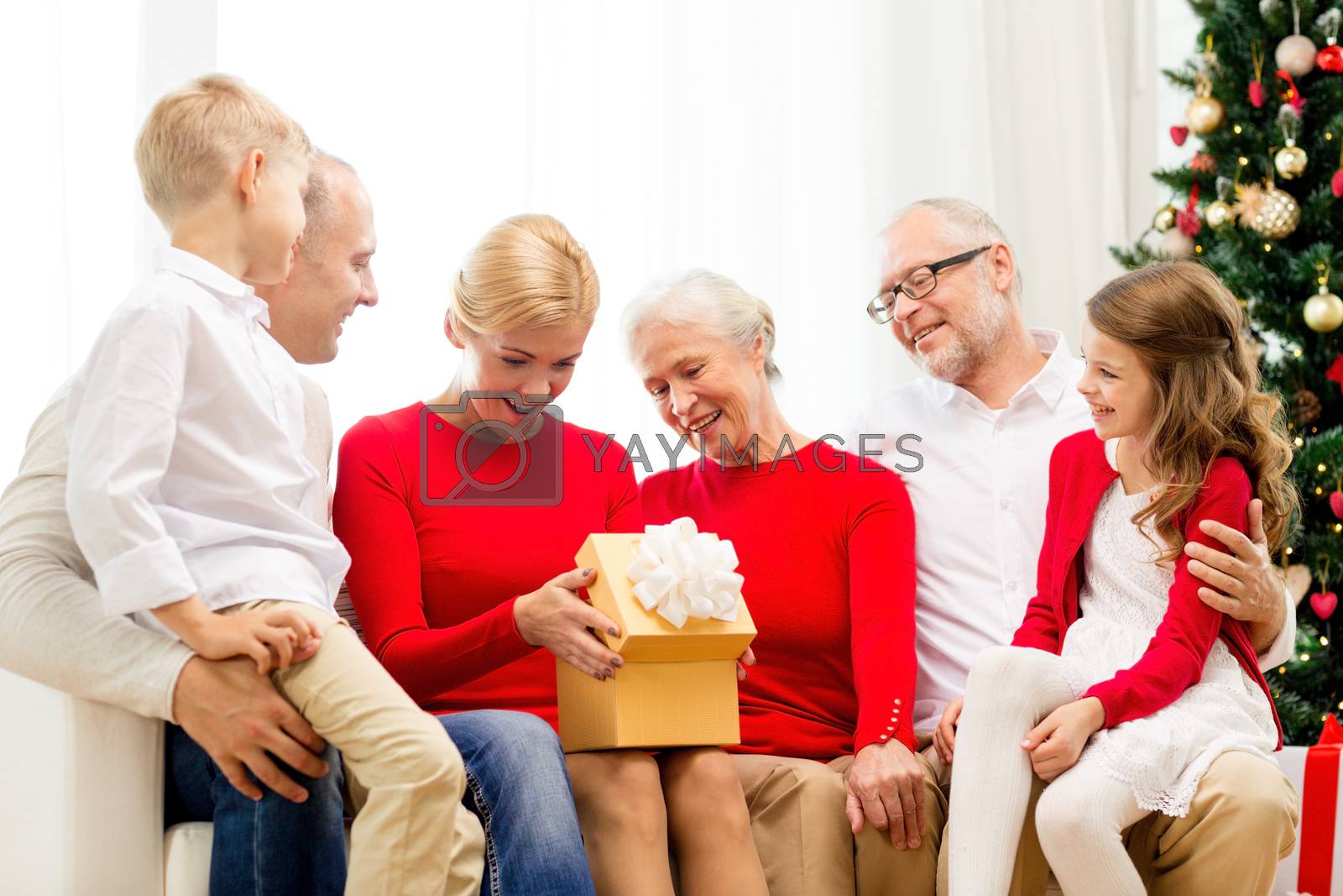 Royalty free image of smiling family with gifts at home by dolgachov