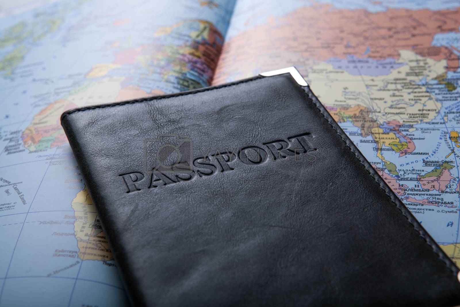 Royalty free image of passport in the bag on a map  by mizar_21984