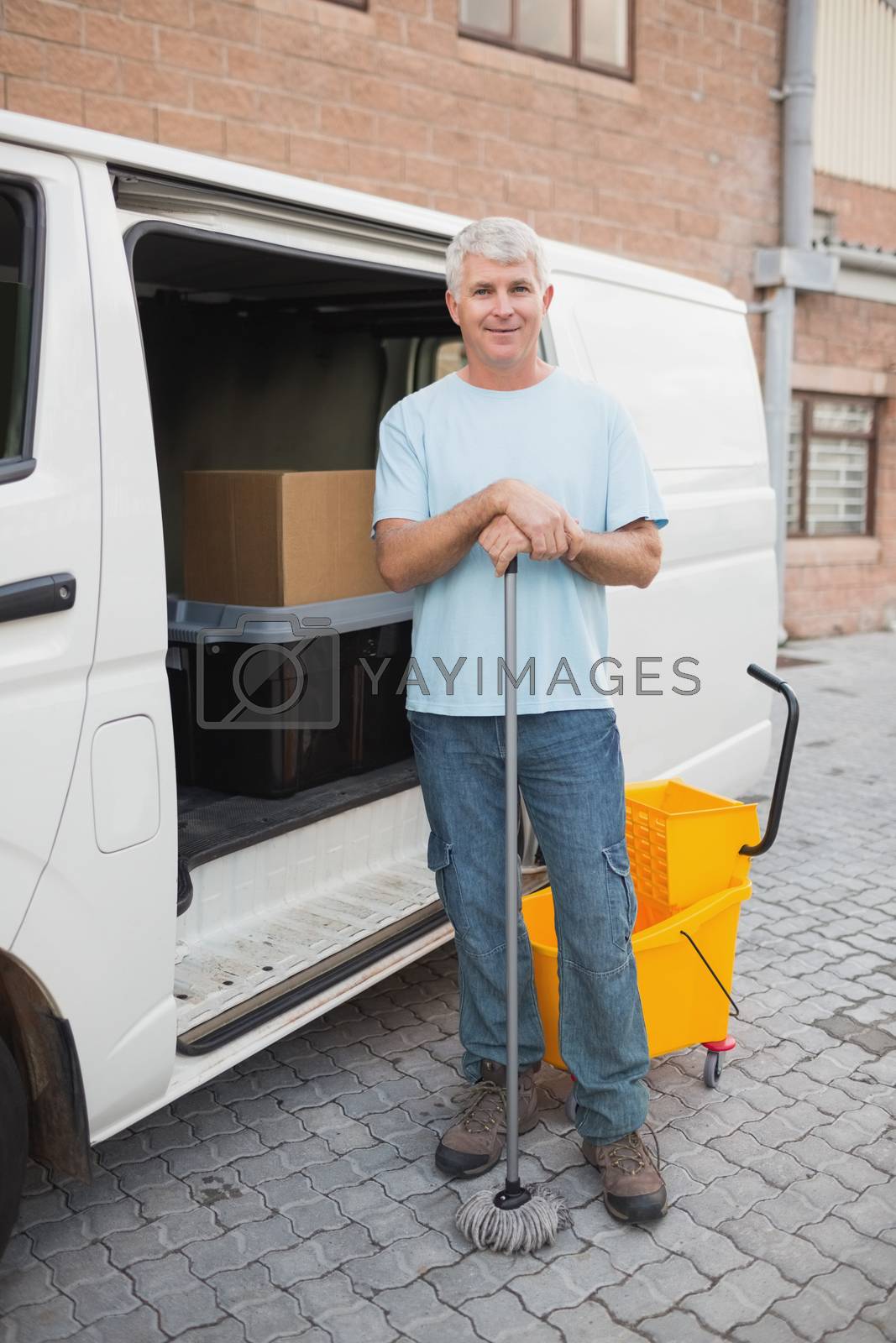 Royalty free image of Janitor by vehicle in front of warehouse by Wavebreakmedia