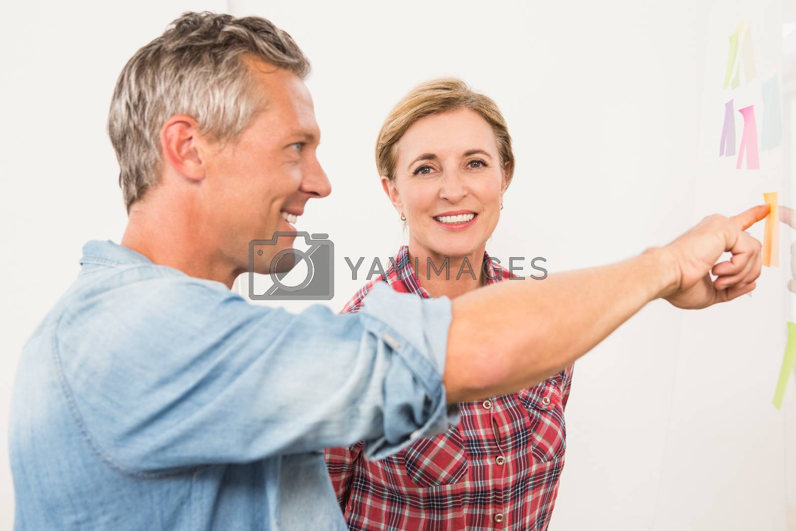 Royalty free image of Smiling businesswoman brainstorming with colleague by Wavebreakmedia
