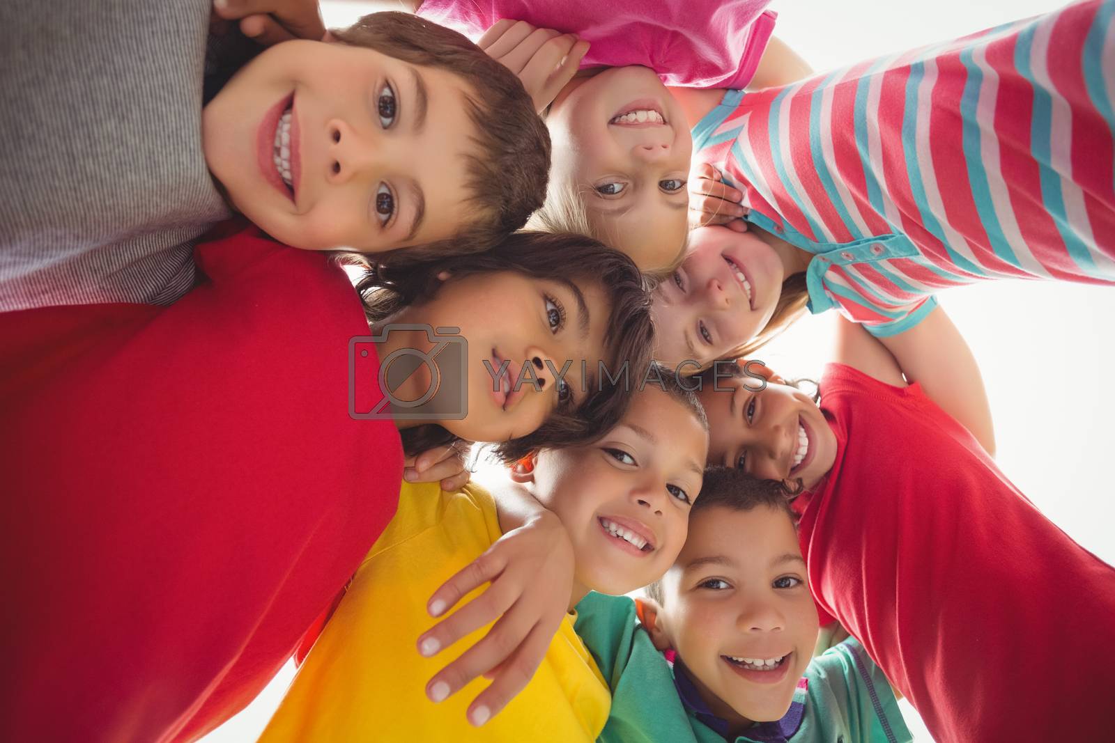 Royalty free image of Cute pupils in a huddle  by Wavebreakmedia