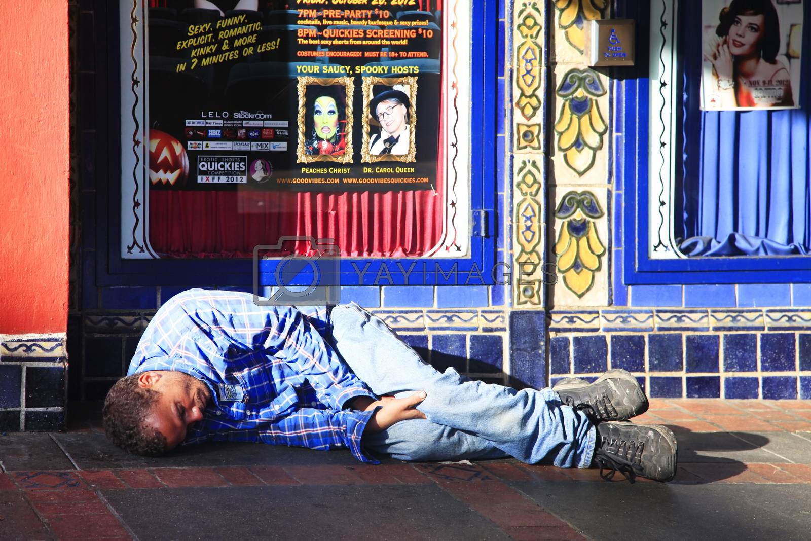 Royalty free image of Homeless man sleeps on the street by friday