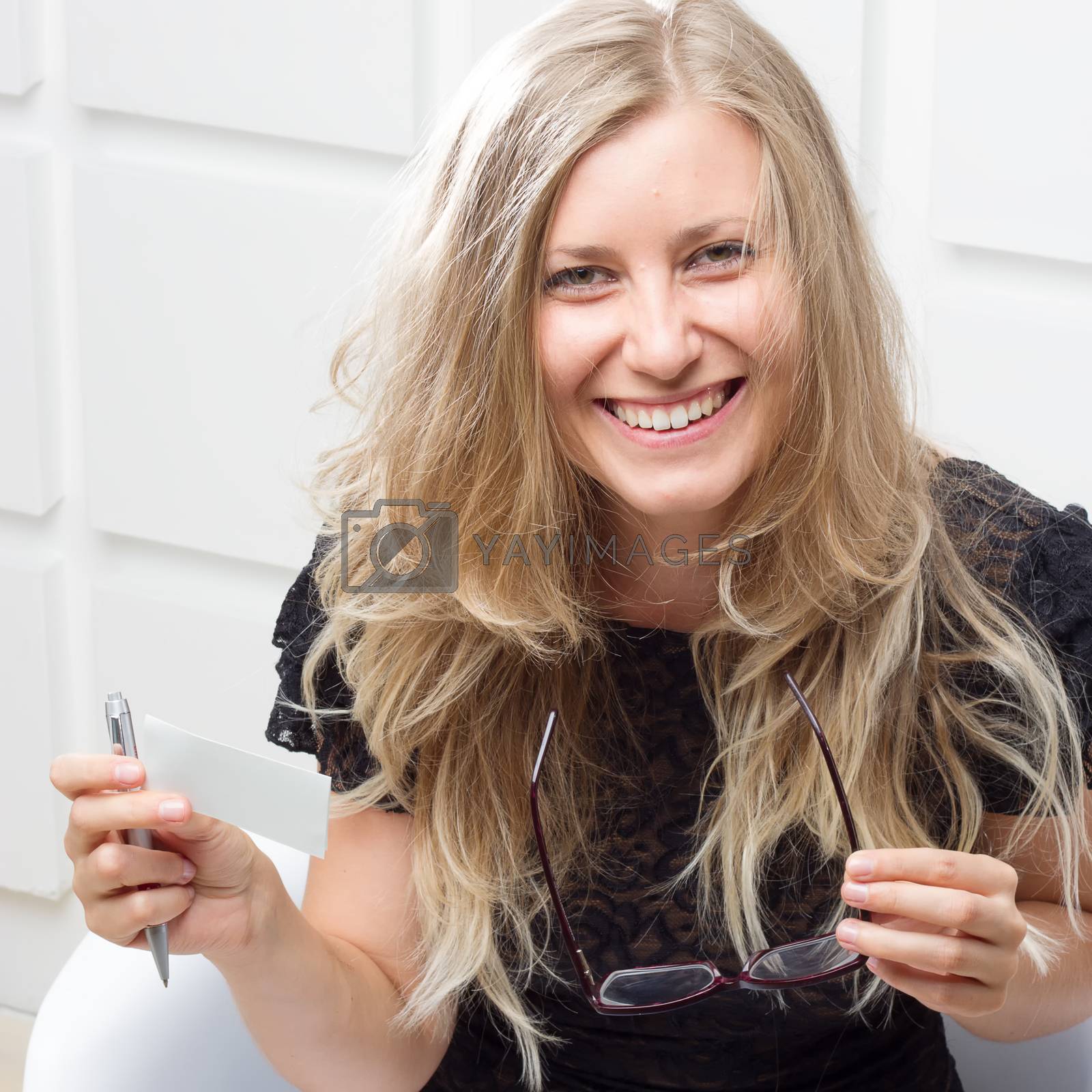 Royalty free image of Smiling woman with a pen by victosha