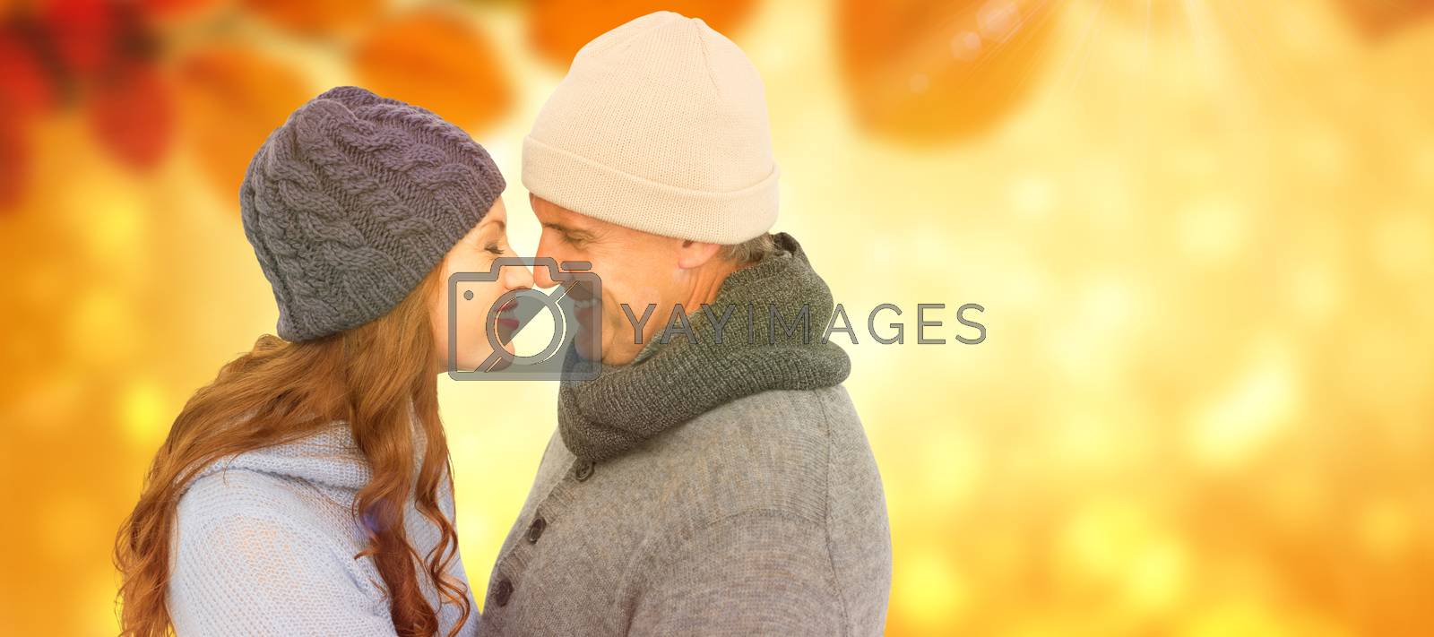Royalty free image of Composite image of couple in warm clothing facing each other by Wavebreakmedia