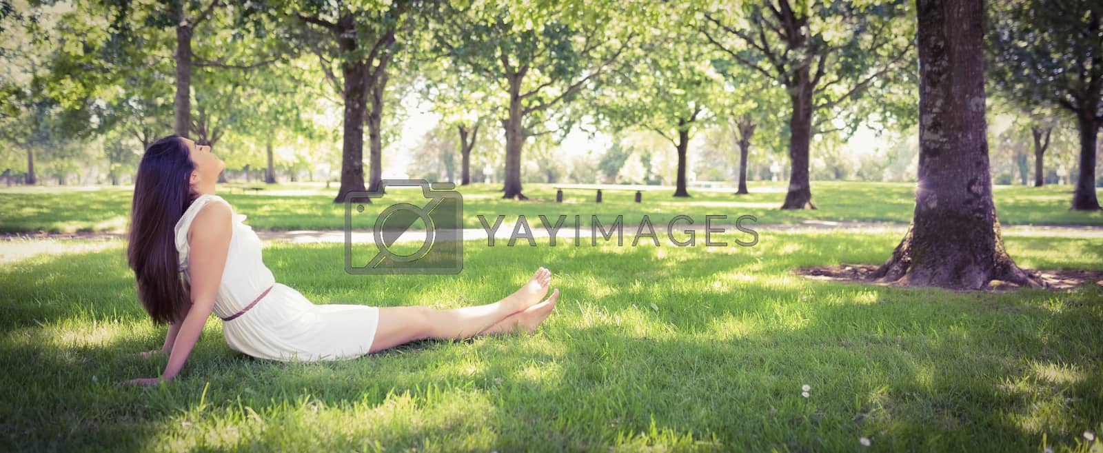 Royalty free image of Young woman relaxing on grassland by Wavebreakmedia