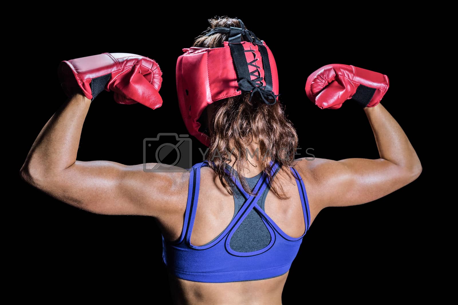 Royalty free image of Rear view of fighter flexing muscles by Wavebreakmedia