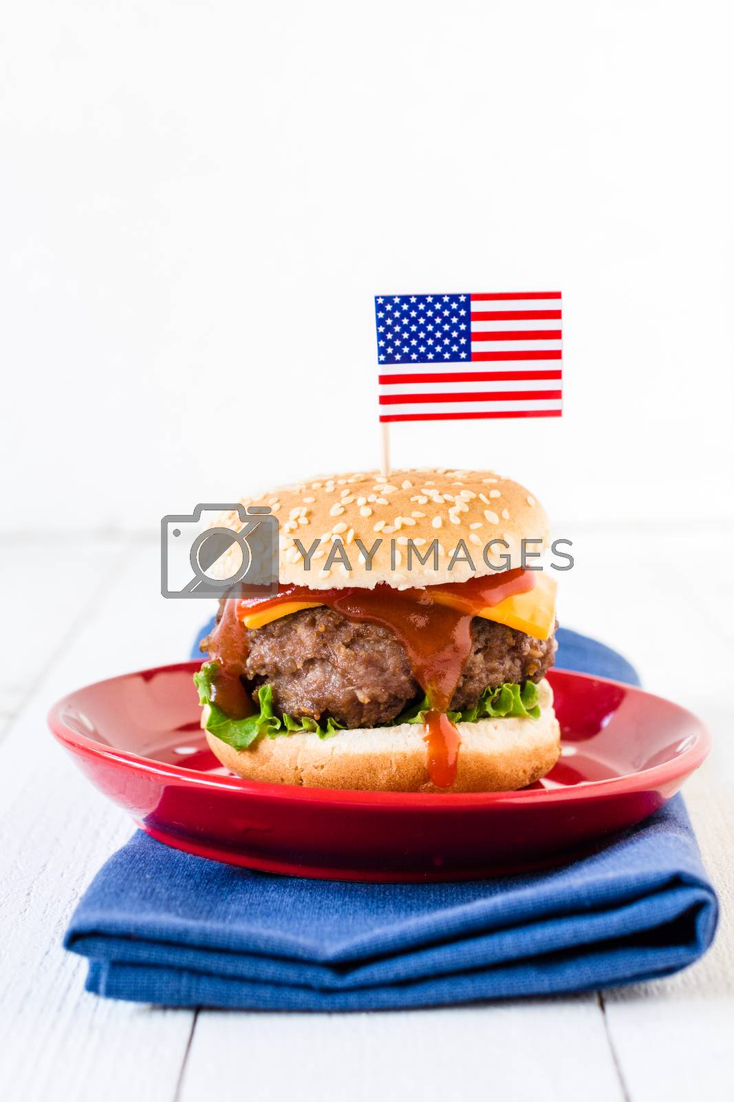 American mini beef burgers with cheese and USA flags,selective focus and blank space