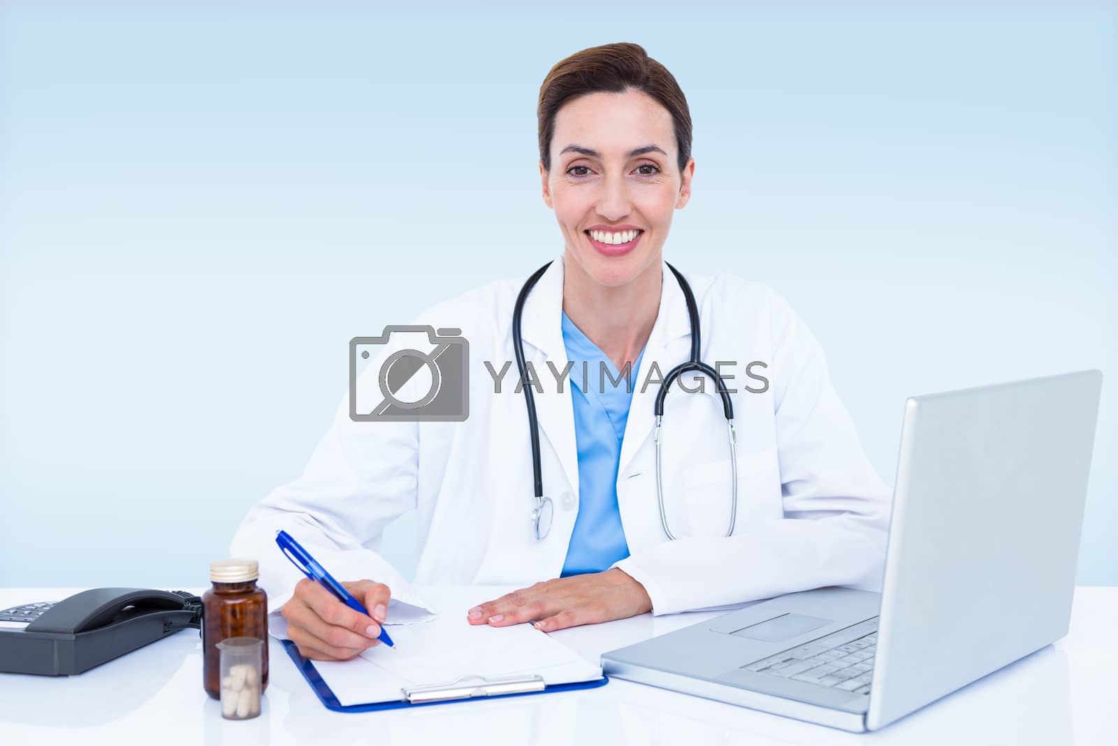 Royalty free image of Composite image of portrait of smiling female doctor writing on pad by Wavebreakmedia