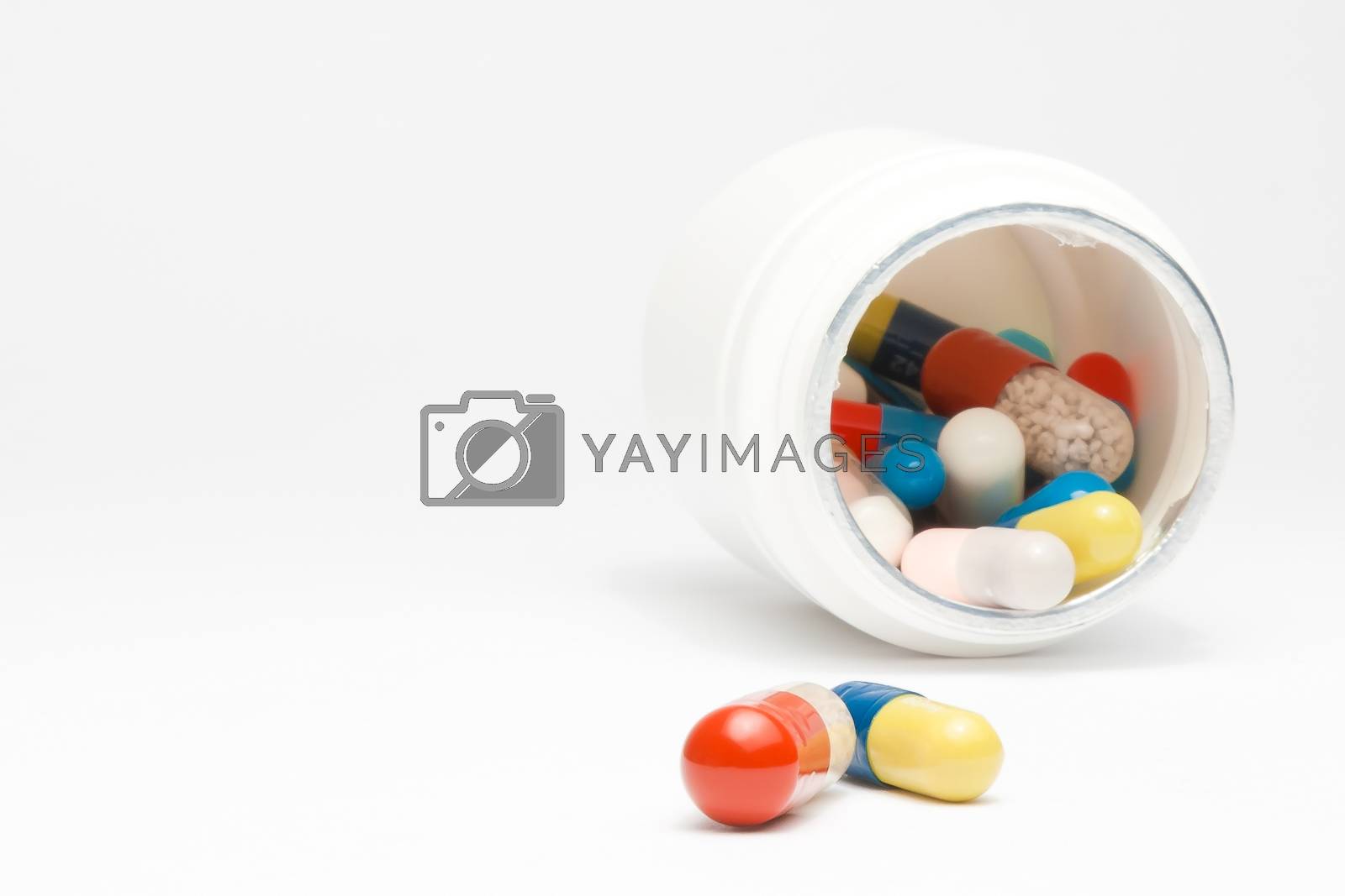 Royalty free image of medical pills in laboratory near white container by donfiore