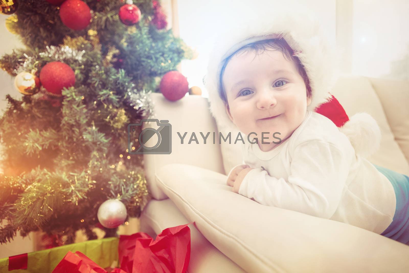 Royalty free image of Cute baby boy on couch at christmas by Wavebreakmedia