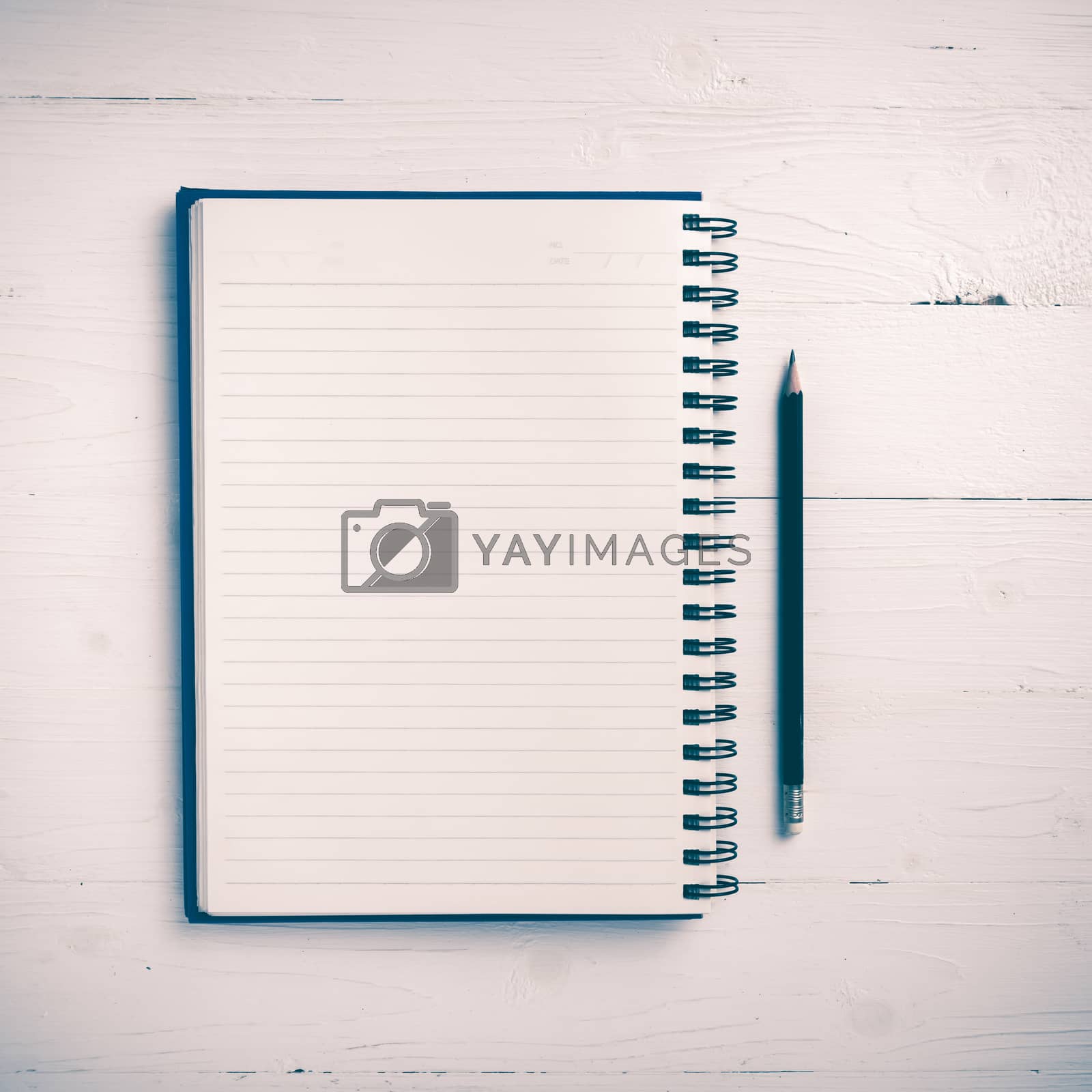 Royalty free image of notepad with pen vintage style by ammza12