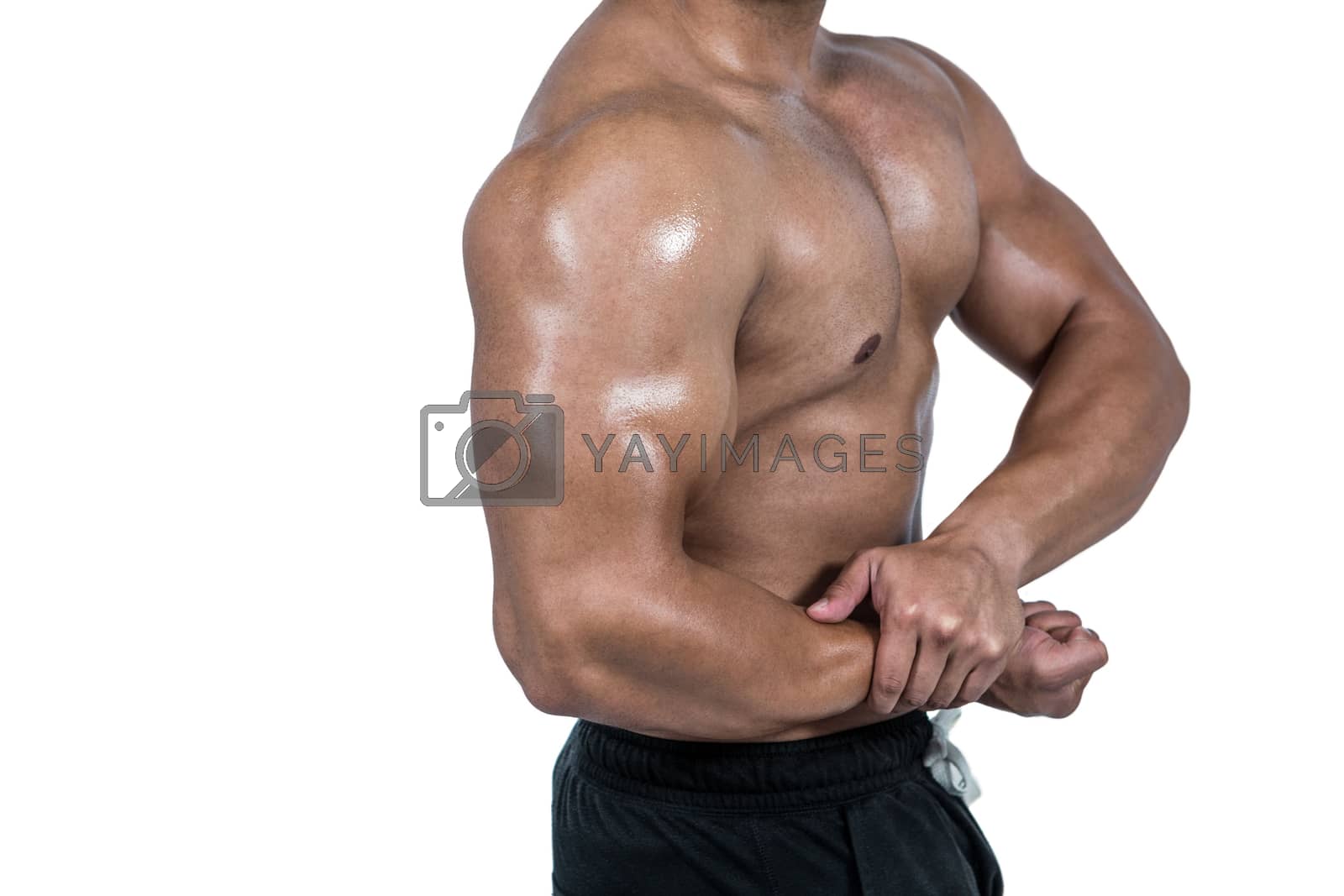 Royalty free image of Muscular man flexing his biceps by Wavebreakmedia