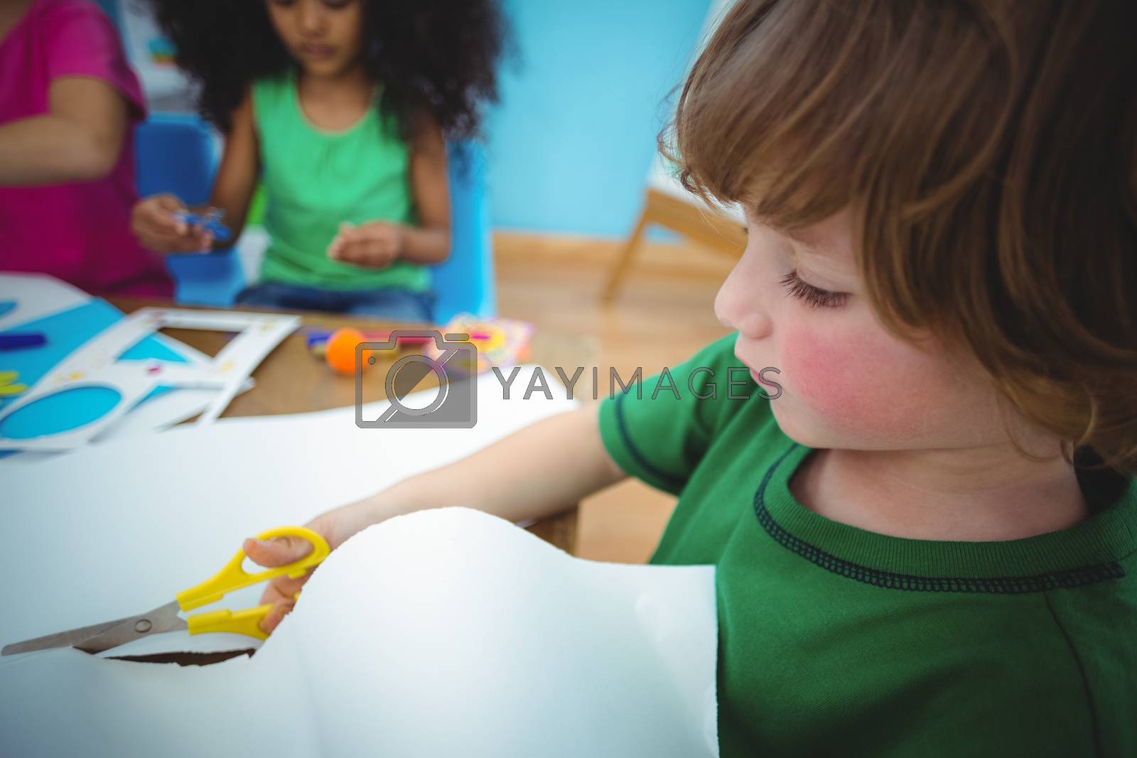 Royalty free image of Happy kids doing arts and crafts together by Wavebreakmedia