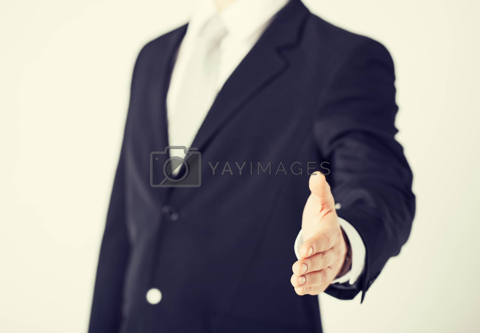 Royalty free image of businessman with open hand by dolgachov