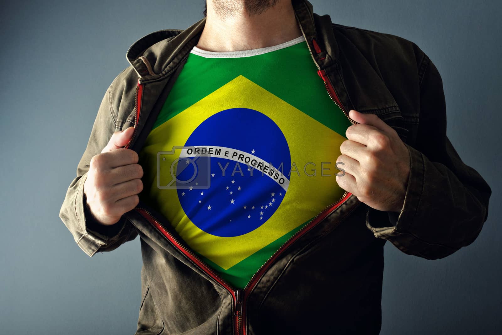 Royalty free image of Man stretching jacket to reveal shirt with Brazil flag by stevanovicigor