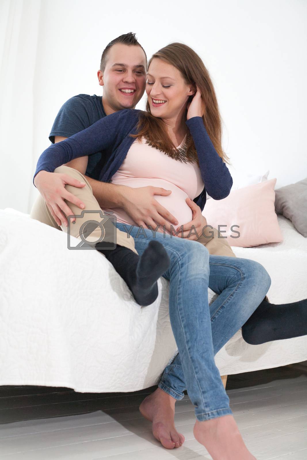 Royalty free image of happy young pregnant couple by DNFStyle