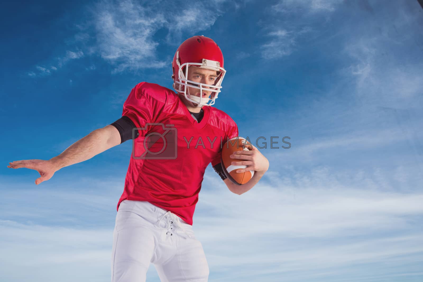 Royalty free image of Composite image of american football player protecting football by Wavebreakmedia