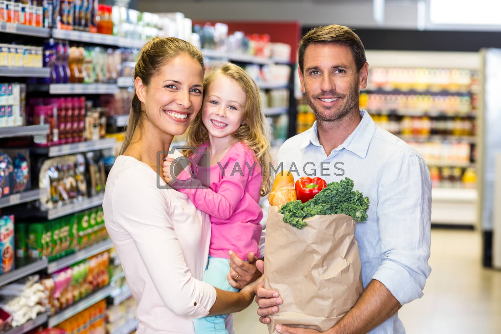 Royalty free image of Smiling family with grocery bag at the supermarket by Wavebreakmedia