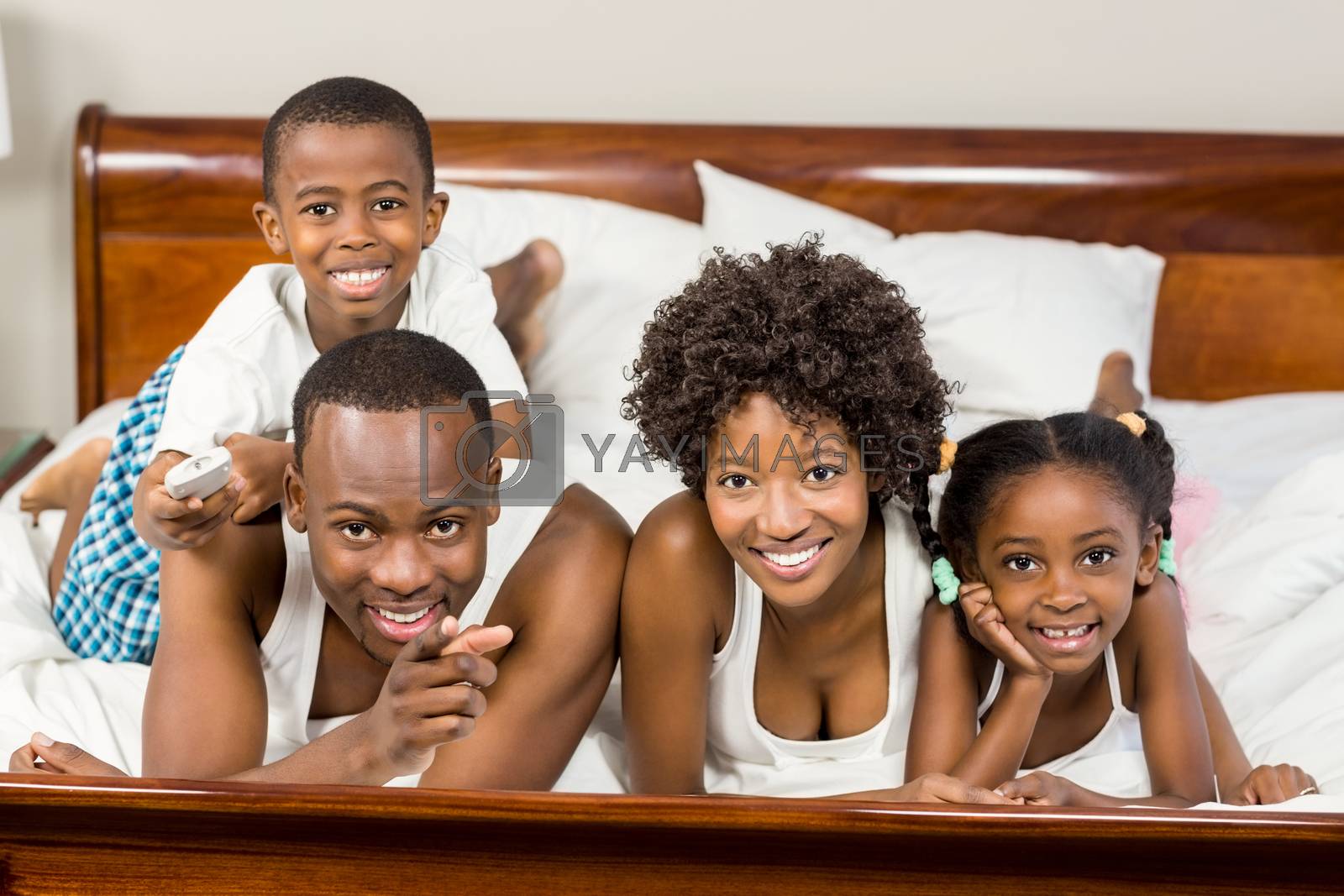 Royalty free image of Happy family lying in bed together by Wavebreakmedia