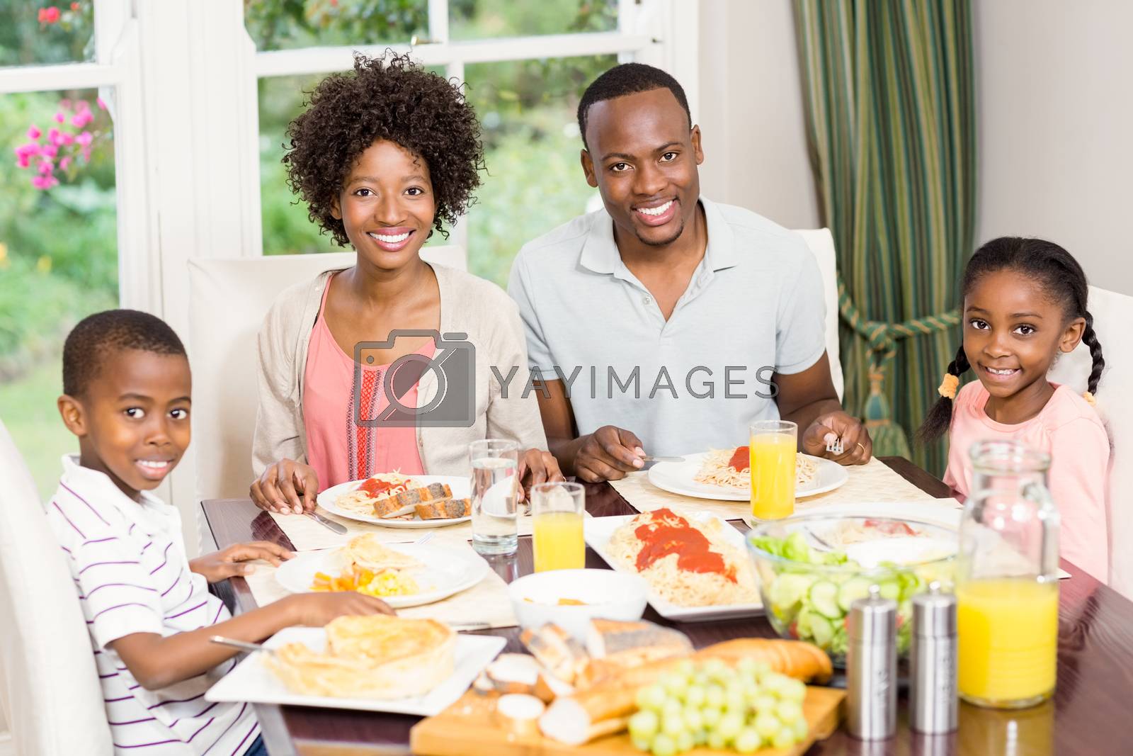 Royalty free image of Portrait of happy family eating together by Wavebreakmedia