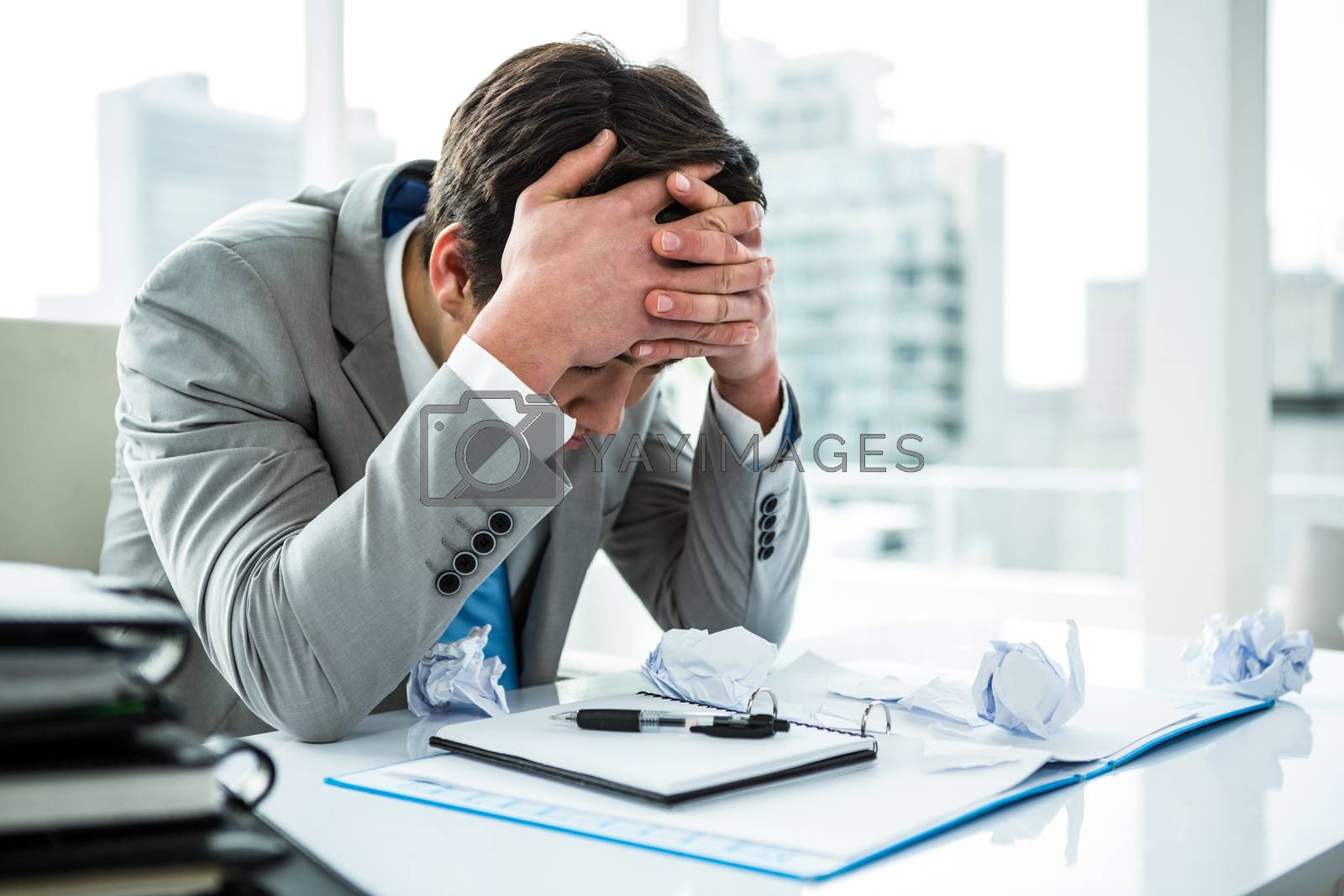 Royalty free image of Businessman being depressed by working by Wavebreakmedia