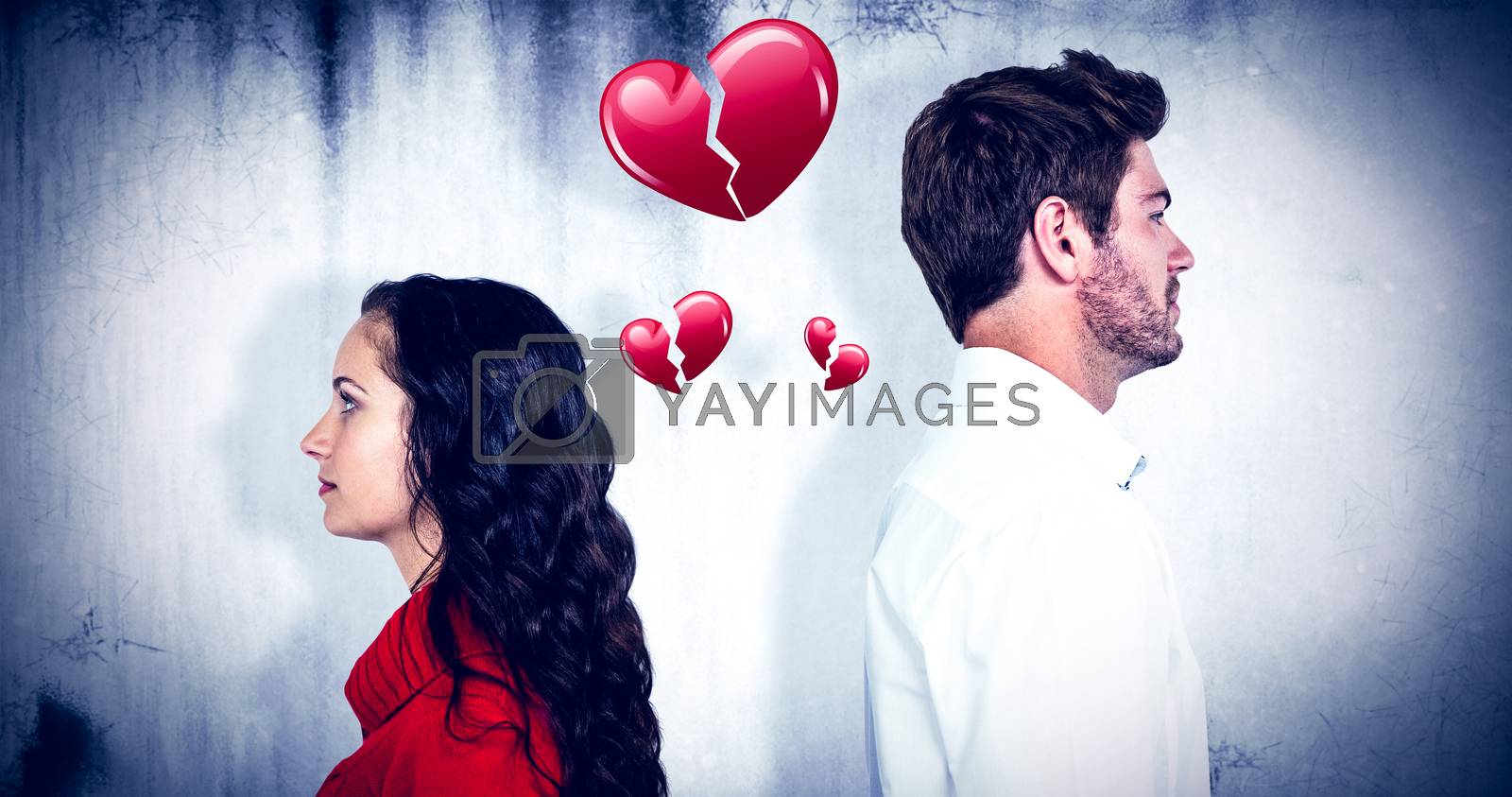 Royalty free image of Composite image of couple standing back to back after arguing by Wavebreakmedia